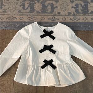Girls White Peplum Top with Black Bow Accents